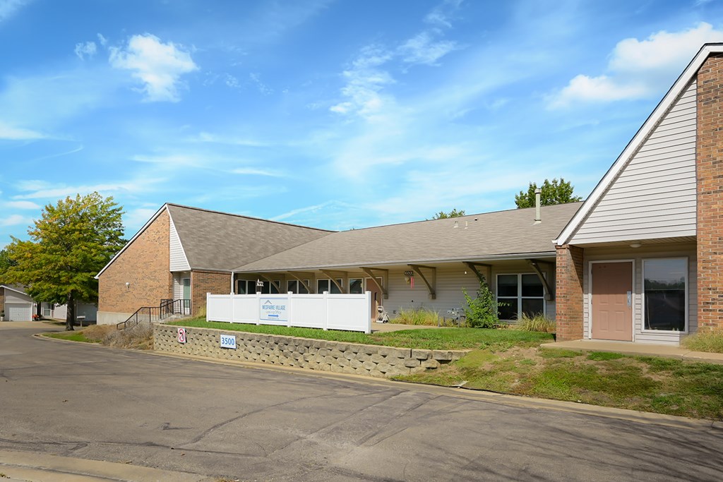 A building with a white fence in front of it.