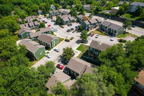 an aerial view of a neighborhood of houses with cars parked