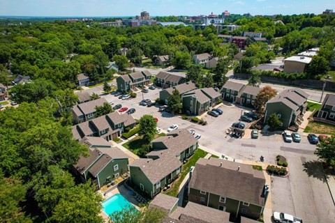 an aerial view of a neighborhood with houses and a swimming pool
