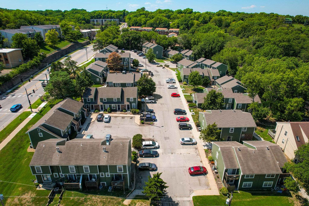 an aerial view of a neighborhood of houses with cars parked