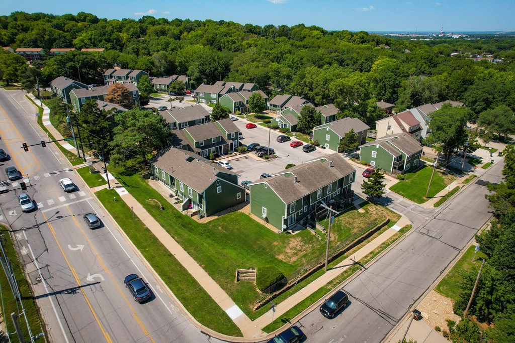 an aerial view of a neighborhood of green and gray houses