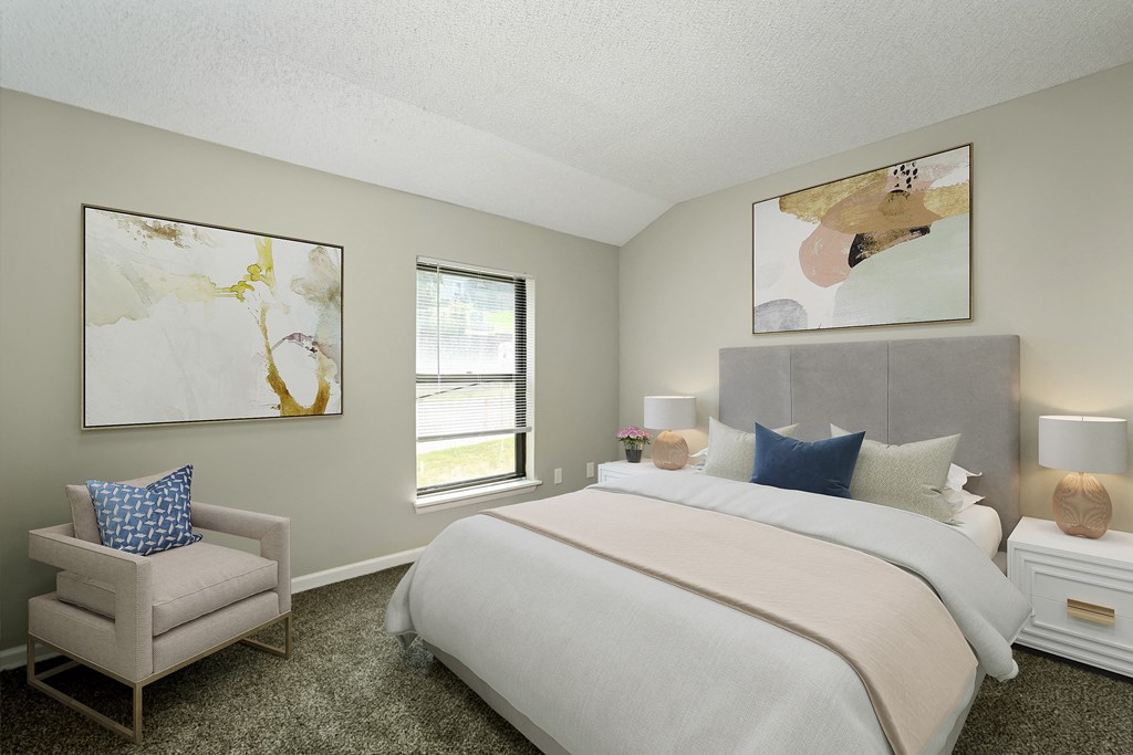 a bedroom with a large bed and two paintings on the wall