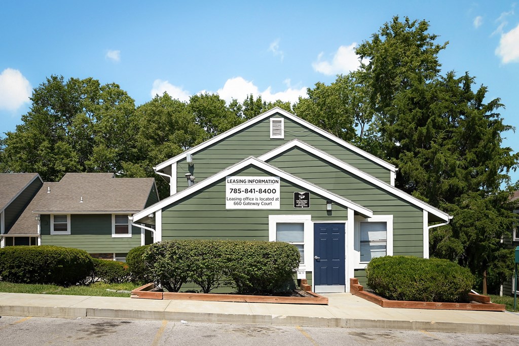 a green house with a sign on the front of it