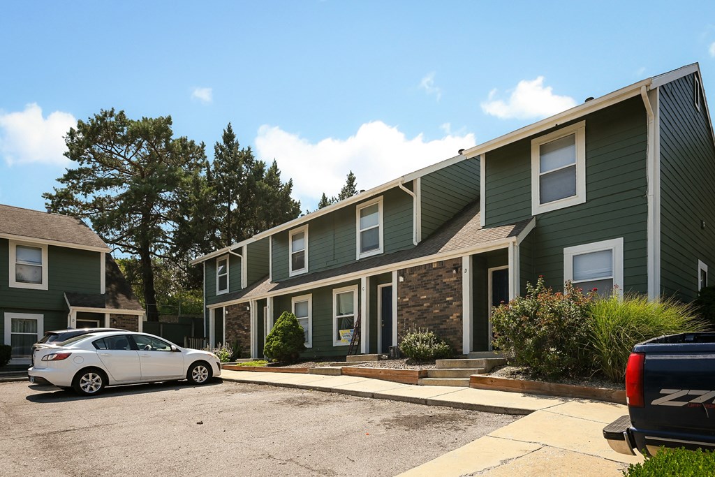an apartment building with a car parked in front of it