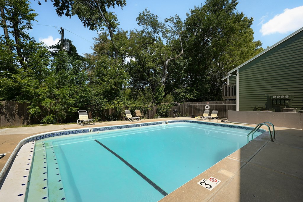 a swimming pool in a backyard next to a house