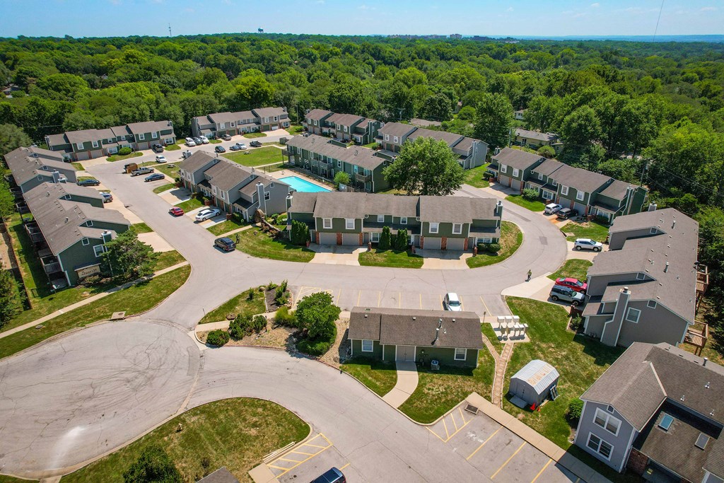 an aerial view of a neighborhood with houses and a swimming pool