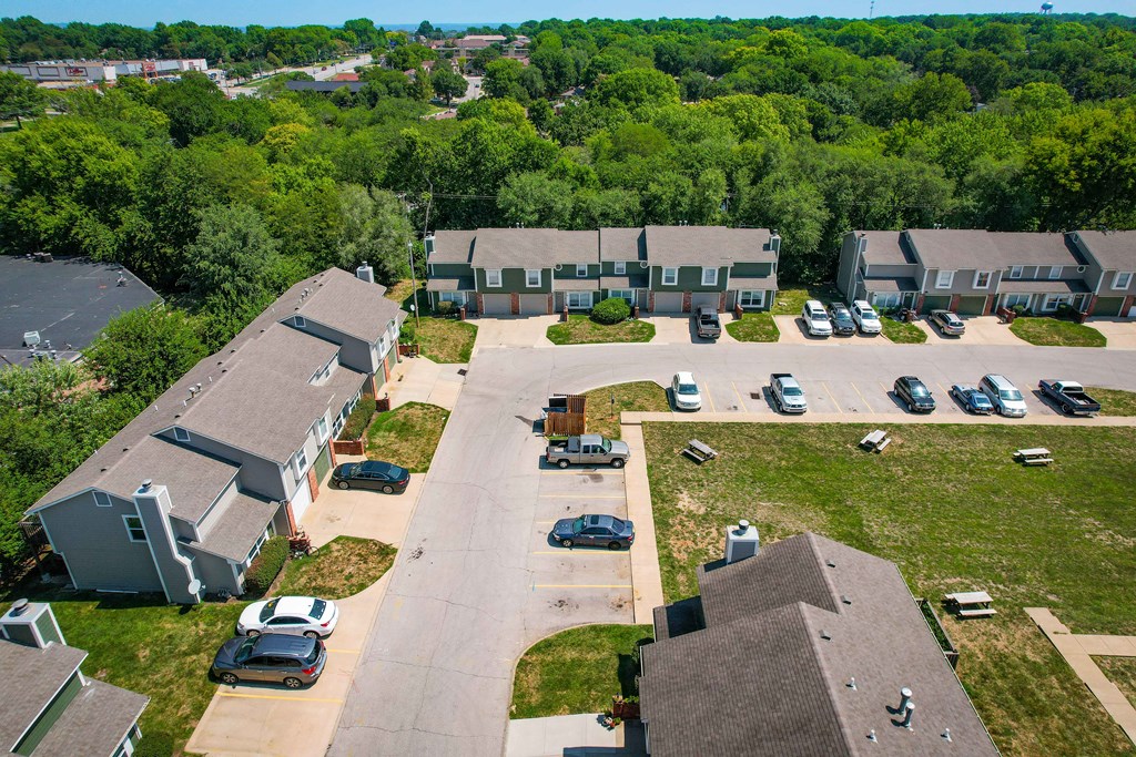 an aerial view of a neighborhood of houses with cars parked