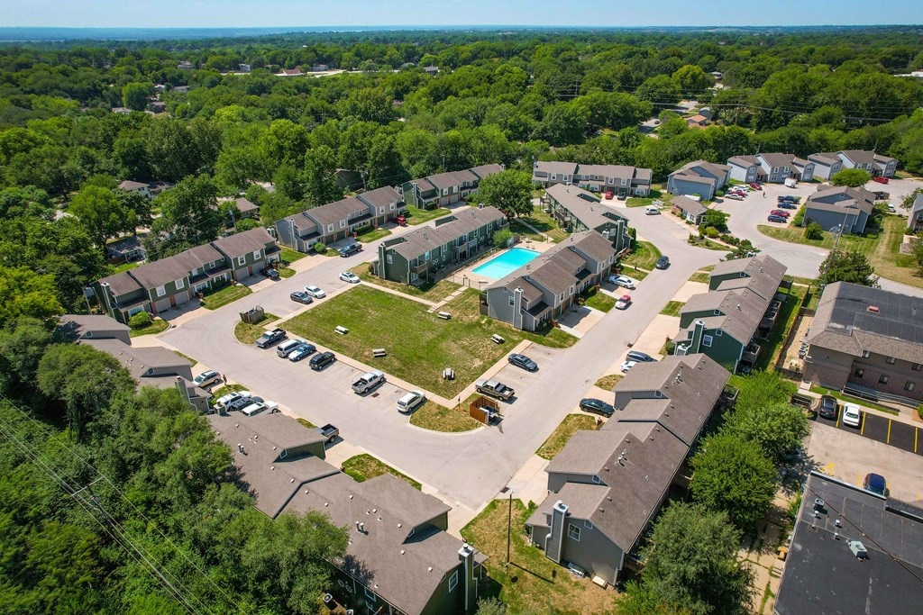 an aerial view of a neighborhood of houses and cars parked