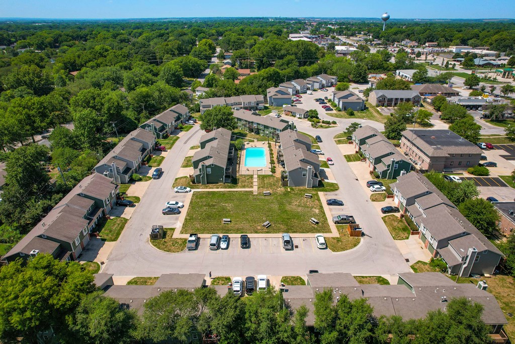 an aerial view of a neighborhood with houses and a pool