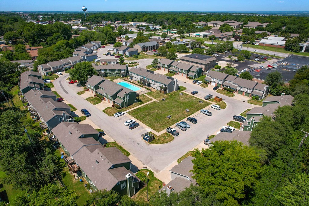 an aerial view of a neighborhood with houses and a parking lot