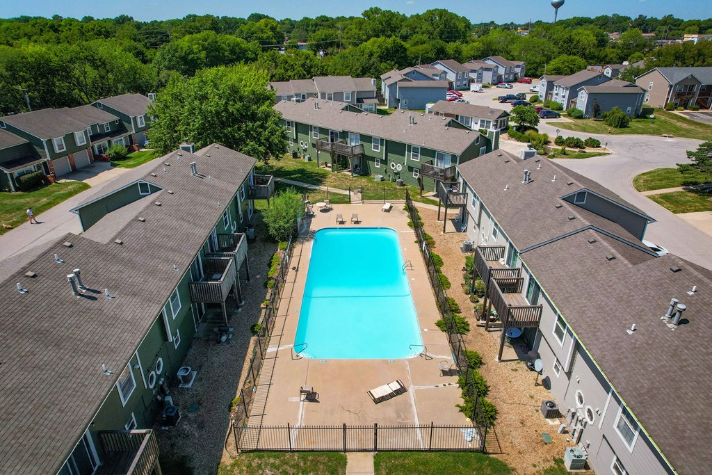 a aerial view of the resort style pool surrounded by buildings