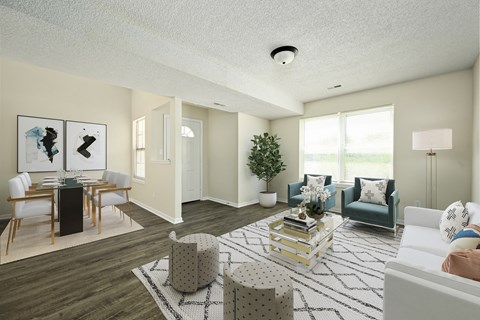 an open living room and dining room with white walls and a large window