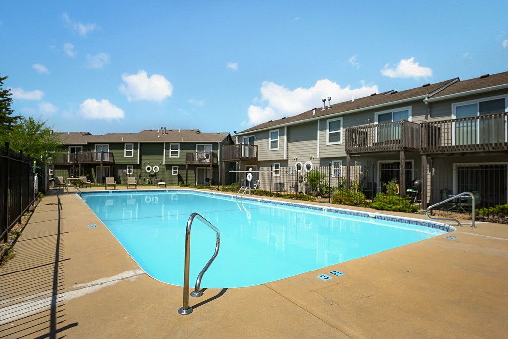 the view of a swimming pool with an apartment building in the background