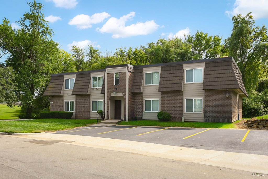A building with a brown roof and grey walls with windows and doors.