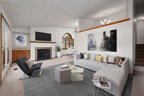 a living room with a white couch and a fireplace