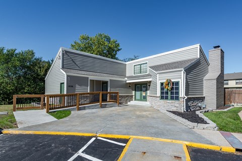 a white house with a porch and a driveway