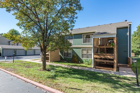a house with a yard and a tree in front of it