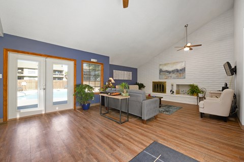 a living room with a couch and a chair and a sliding glass door