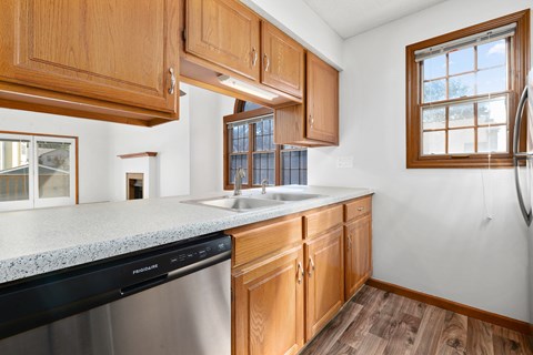 a kitchen with wooden cabinets and a counter top and a sink