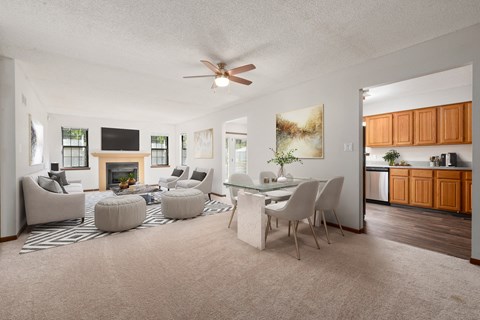 a living room with couches and a dining table