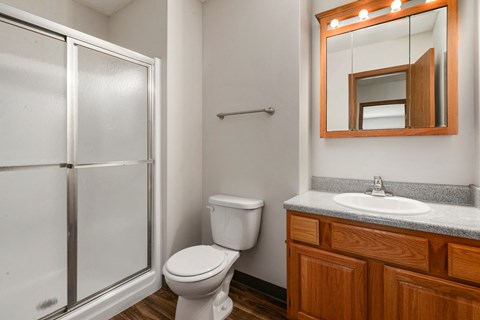 a small bathroom with a shower toilet and sink