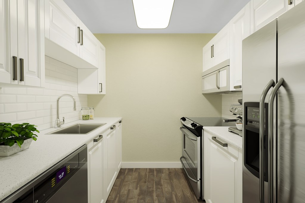 A kitchen with white cabinets and stainless steel appliances.