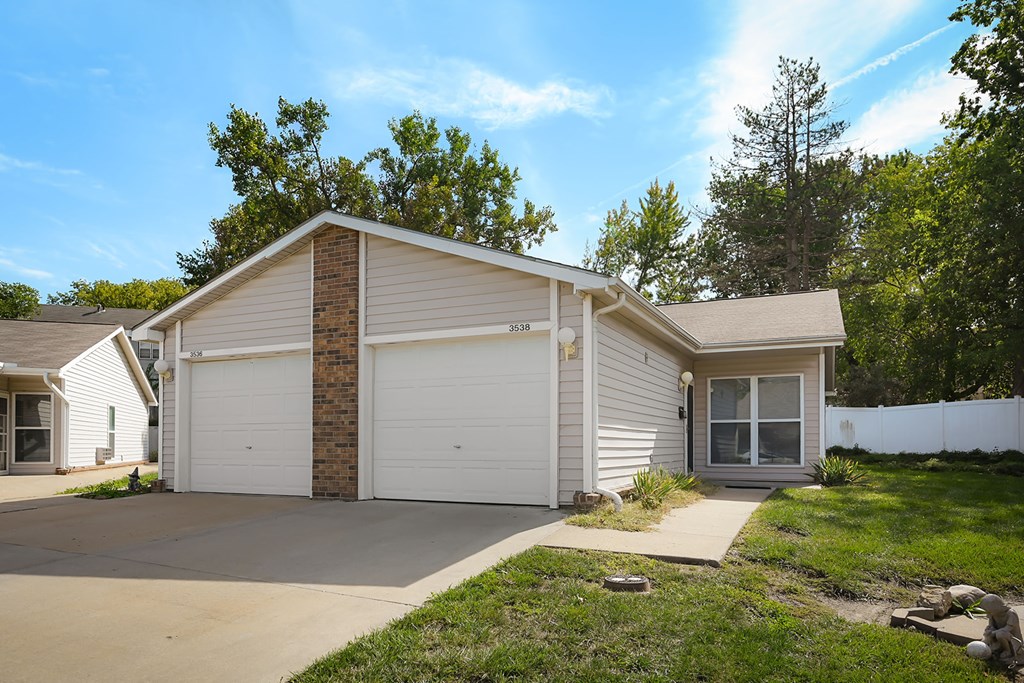 A two-car garage is attached to a house.