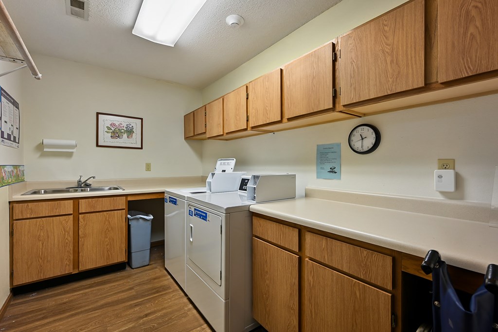 A small laundry room with a washer and dryer.