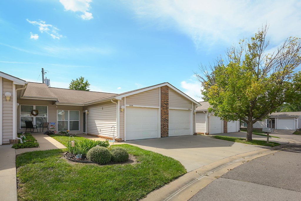 A residential area with houses and a tree.