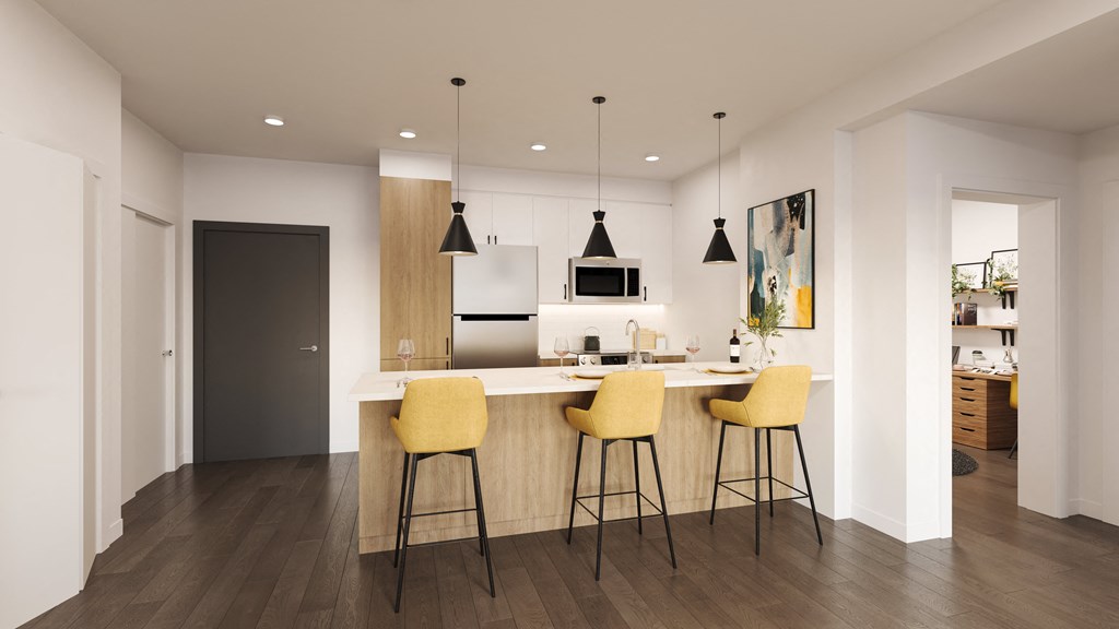 a kitchen with a bar and yellow chairs