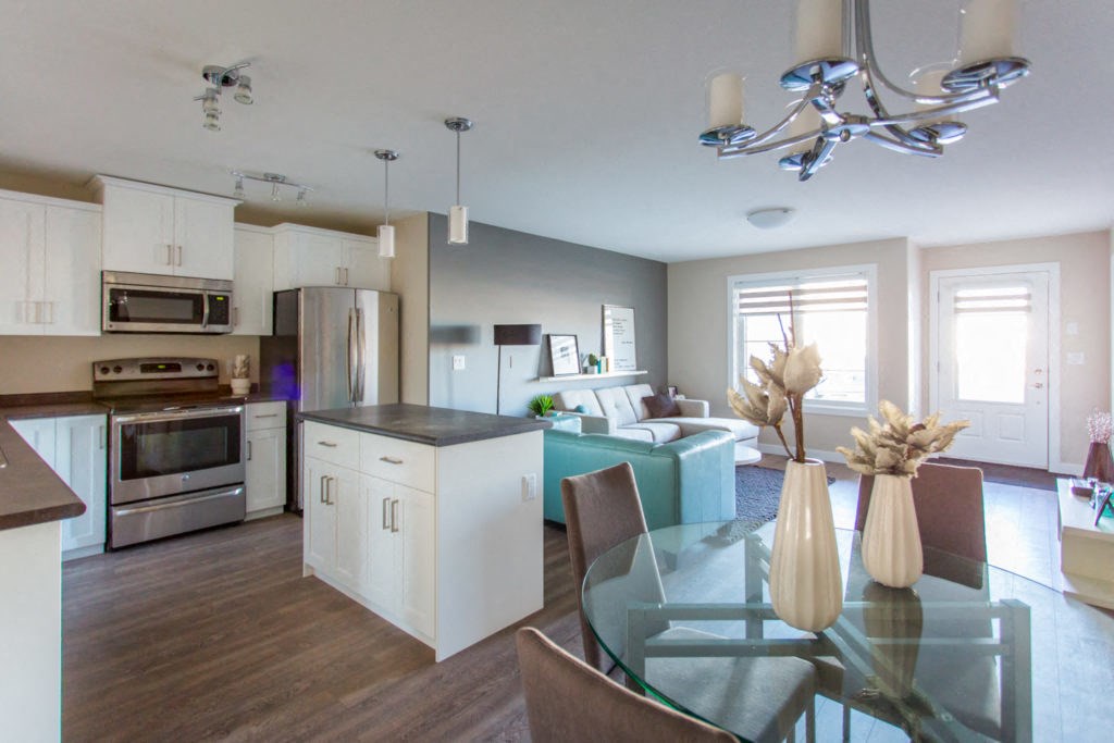 Interior wide shot of kitchen and dining area.