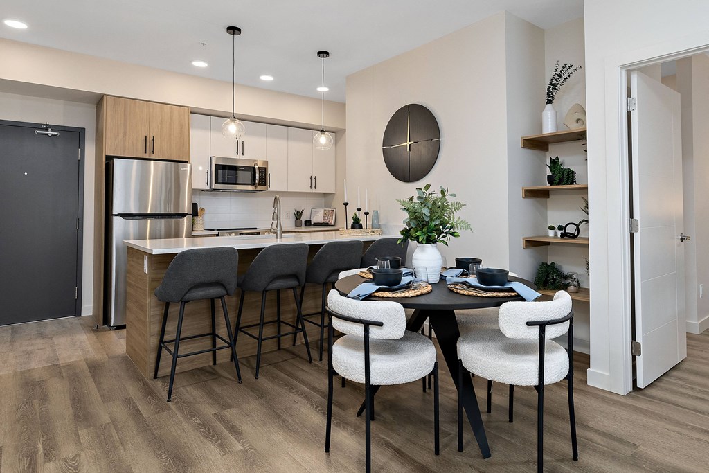 an open kitchen and dining room with a table and chairs