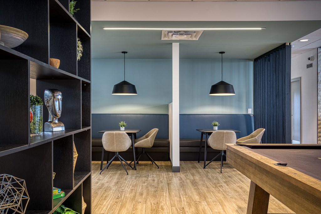 A modern dining area with a wooden table and chairs.