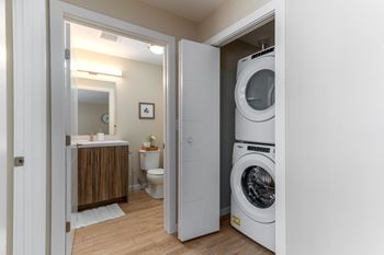 a washer and dryer in a bathroom next to a toilet