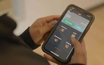 A person is holding a phone with a screen displaying a menu with different options.