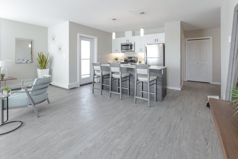 A modern kitchen with a dining table and chairs.