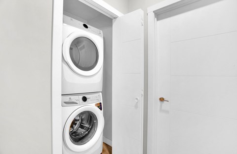 A white washing machine and dryer in a small laundry room.