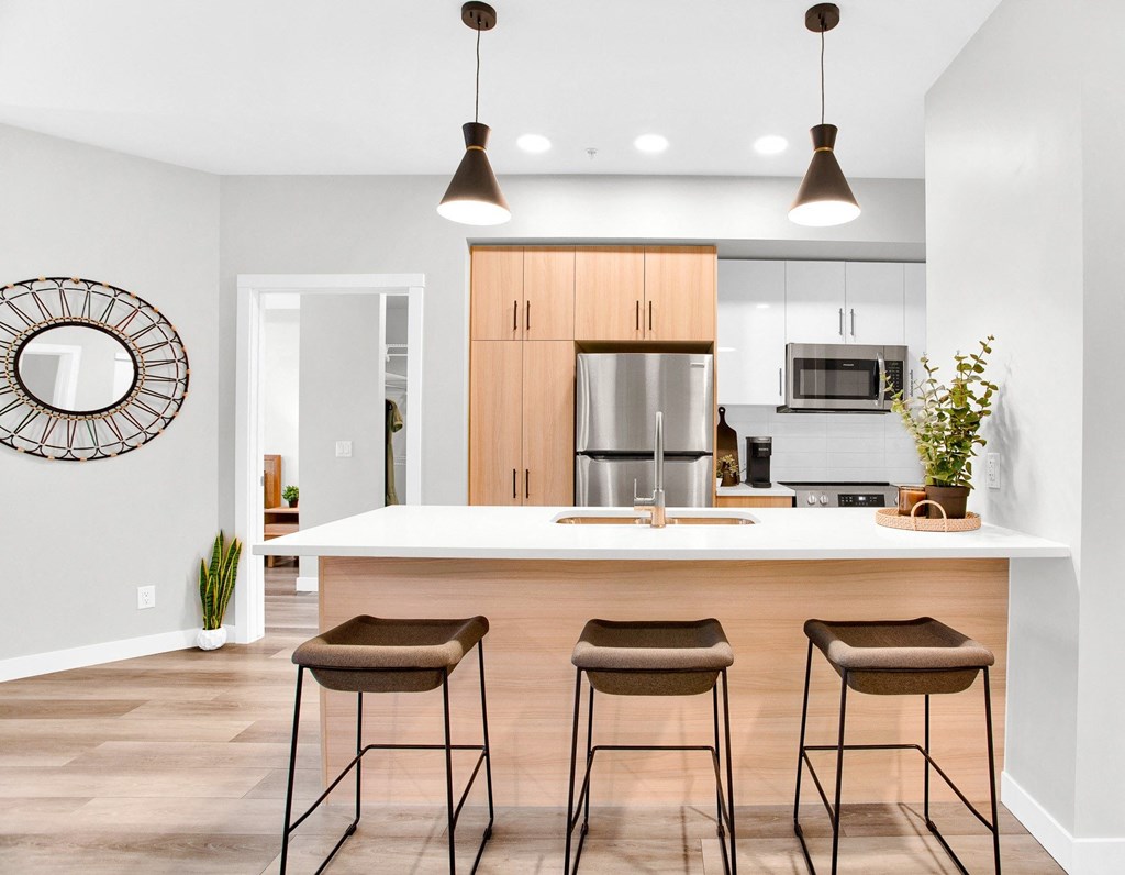 a kitchen with a island and three stools
