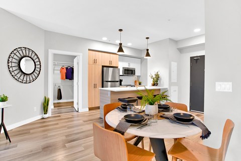 A modern dining room with a round table and chairs.