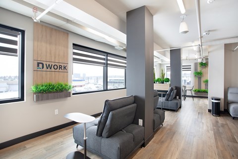 A modern office space with a sign that reads "WORK" on the wall.