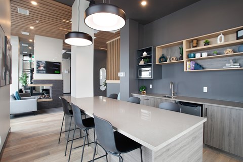 A modern kitchen with a large island and bar stools.