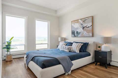 A Bedroom With Two Windows at Podium Apartments, Alberta, T2E 7J2