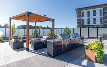A patio area with a grill and seating area.