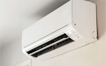 A white air conditioner unit mounted on a wall.