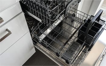 A close up of a dishwasher with the door open.