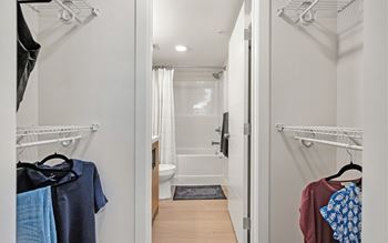 A white bathroom with a toilet, sink, and shower.