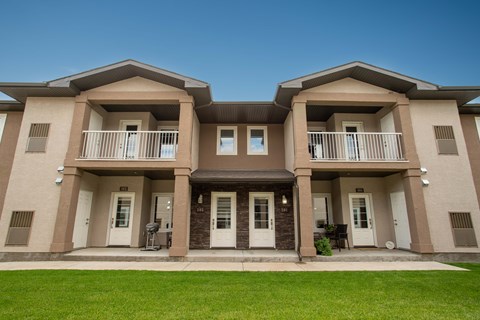 A two-story house with a balcony on the second floor.