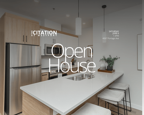 A modern kitchen with a large island and stainless steel appliances.