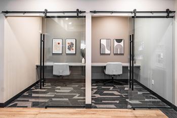 IT/Business centre with chairs, tables and a glass door
