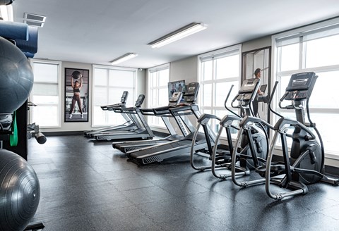 A Gym With Treadmills at Podium Apartments, Calgary, AB